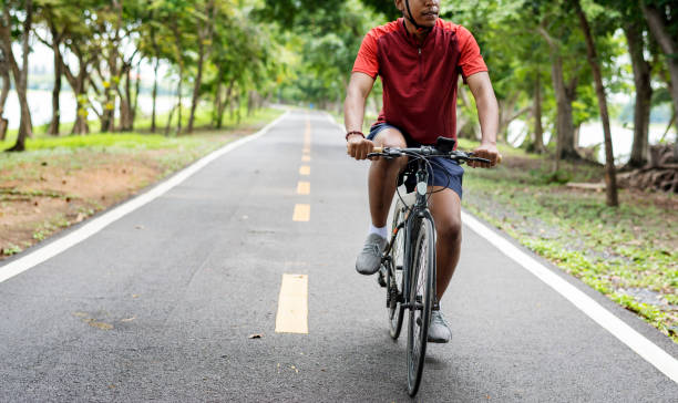 istock Cyclist riding a bike in a park 1044267976