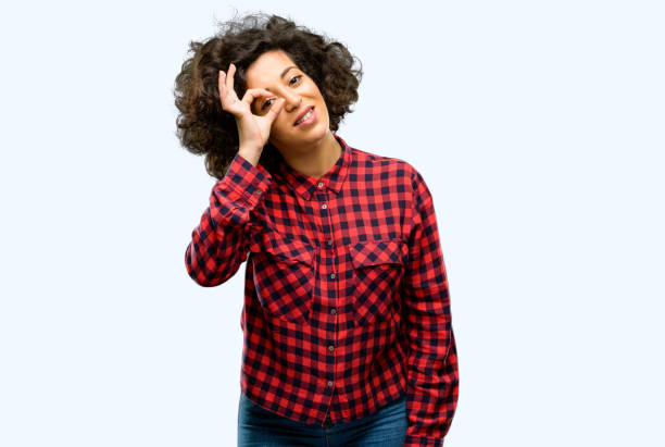 istock Beautiful arab woman looking at camera through fingers in ok gesture. Imitating binoculars, beautiful eyes and smile 1044268040