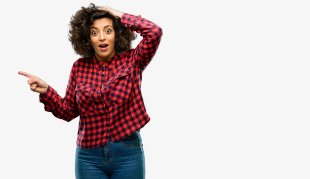 istock Beautiful arab woman pointing away side with finger 1044268344