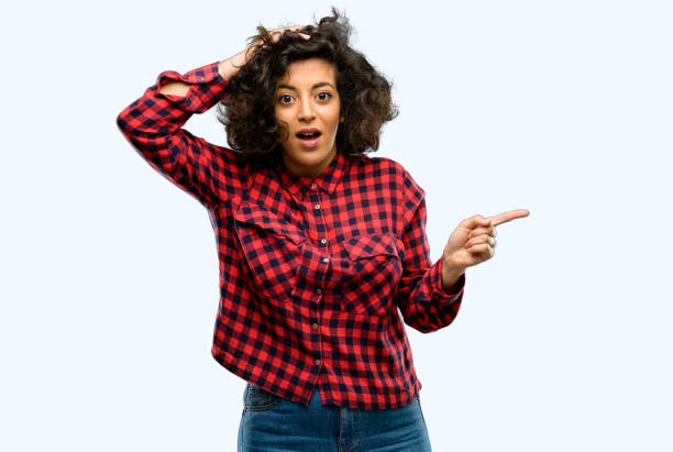 istock Beautiful arab woman pointing away side with finger 1044268356