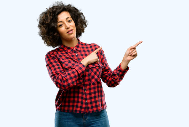 istock Beautiful arab woman pointing away side with finger 1044270520