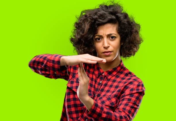 istock Beautiful arab woman serious making a time out gesture with hands 1044270522