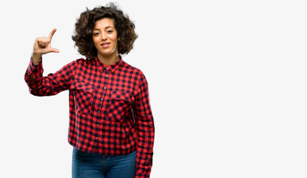 istock Beautiful arab woman holding something very tiny, size concept 1044270664
