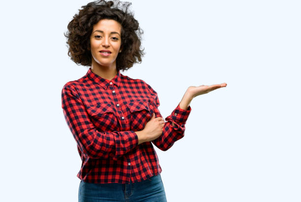 istock Beautiful arab woman holding something in empty hand 1044271770