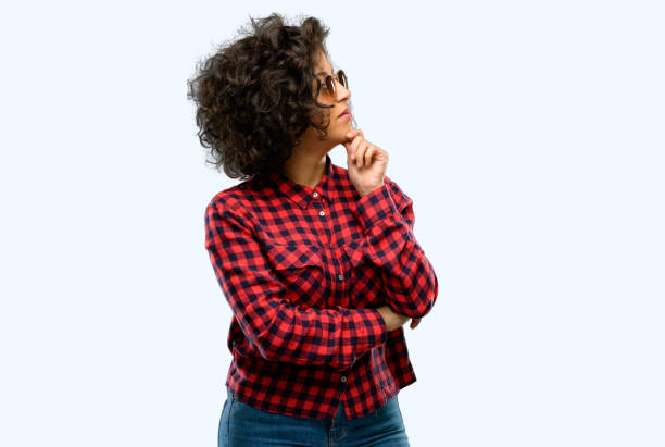 istock Beautiful arab woman thinking and looking up expressing doubt and wonder 1044271832
