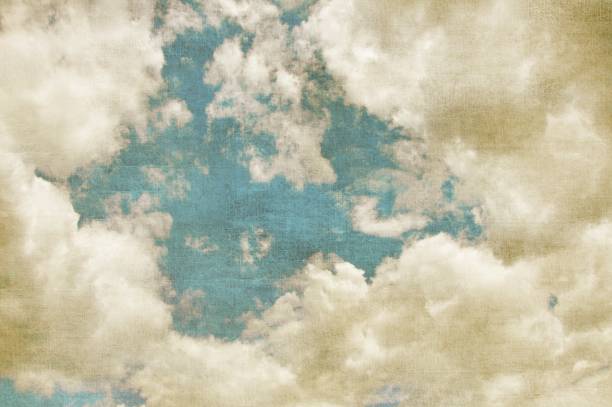 Blue sky with white clouds in retro grunge style. Nature background.