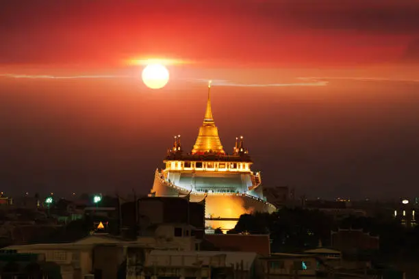 Wat Sraket Rajavaravihara Golden Mount , sun moving behind the temple.