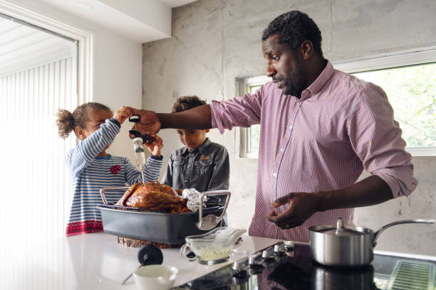istock Fathers preparing thanksgiving turkey 1044276358