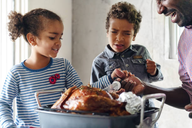 istock Fathers preparing thanksgiving turkey 1044276360