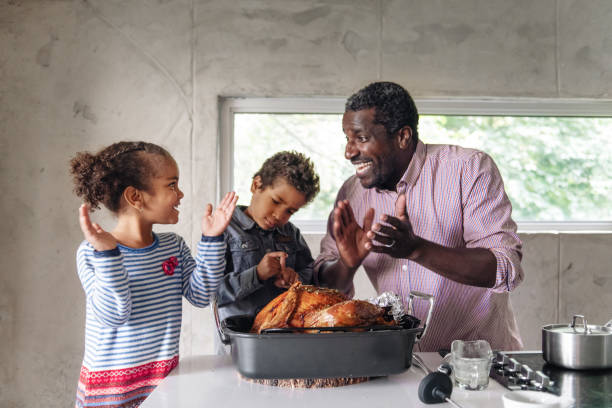 istock Fathers preparing thanksgiving turkey 1044276466