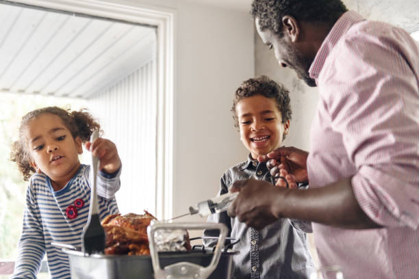 istock Fathers preparing thanksgiving turkey 1044276474