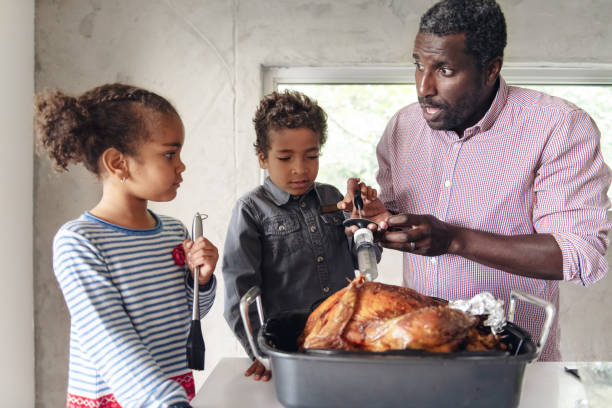 istock Fathers preparing thanksgiving turkey 1044276718