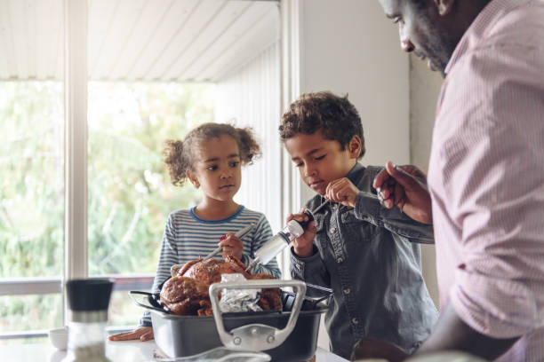 istock Fathers preparing thanksgiving turkey 1044276772