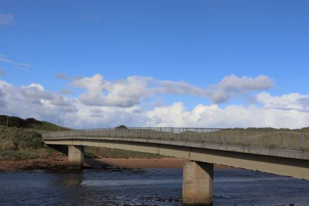 istock Concrete footbridge over river with metal railings 1044277098