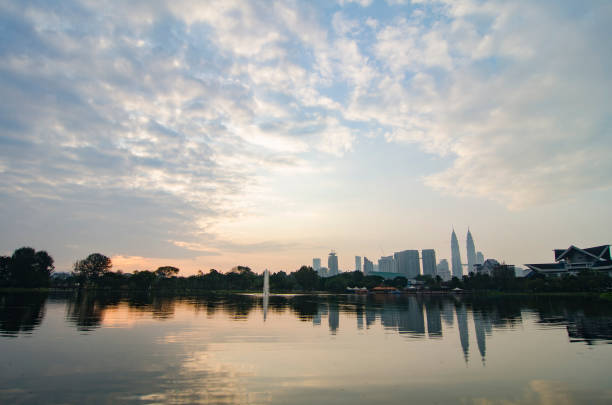 istock Kuala Lumpur City with reflection on the lake and dramatic cloud during sunrise 1044277468