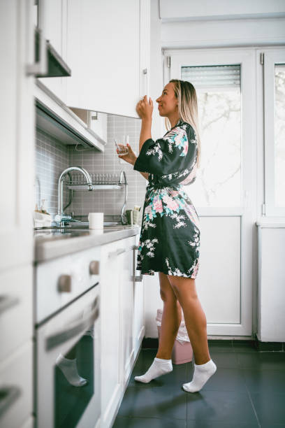 Cute Girl Is Searching For A Coffee From Kitchen Pantry