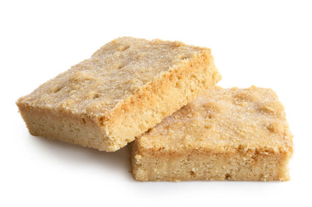 istock Two classic homemade square shortbread biscuits isolated on white. 1044280298
