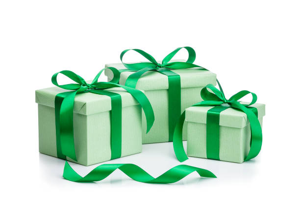 istock Three green gift boxes with green ribbons isolated on white background 1044280790