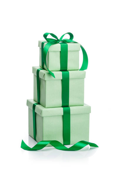 Three green gift boxes with green ribbons isolated on white background