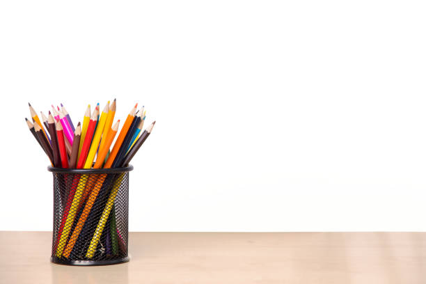 istock Colored pencils in a glass on a wooden table 1044283566