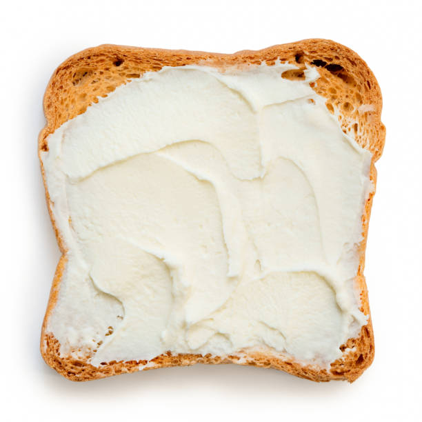 istock Melba toast with cream cheese isolated on white from above. 1044284242