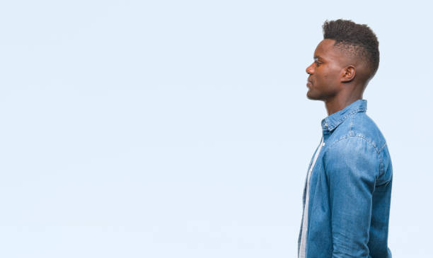 istock Young african american man over isolated background looking to side, relax profile pose with natural face with confident smile. 1044284366