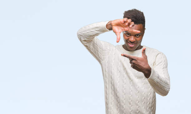 istock Young african american man over isolated background smiling making frame with hands and fingers with happy face. Creativity and photography concept. 1044284450