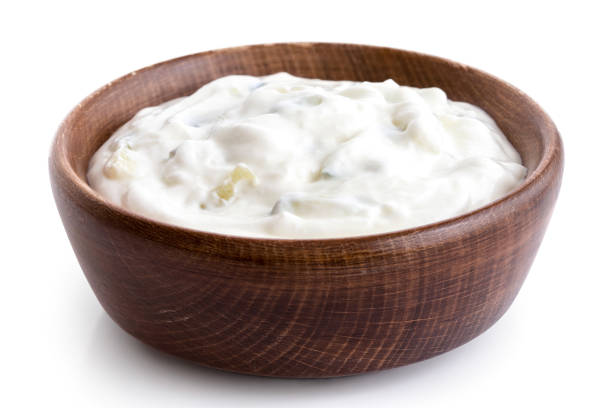 istock Tzatziki in brown rustic wood bowl isolated on white. 1044287852