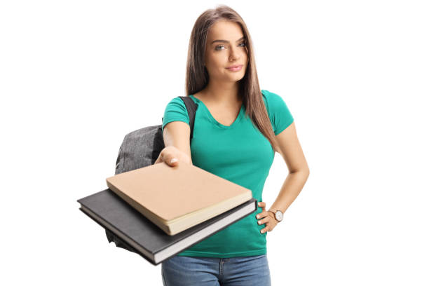 Female student giving books isolated on white background