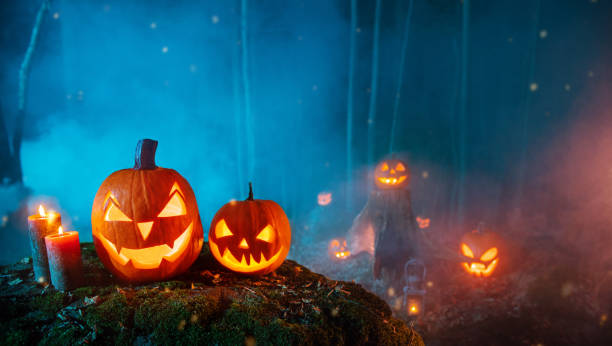 istock Spooky halloween pumpkins in forest 1044291664