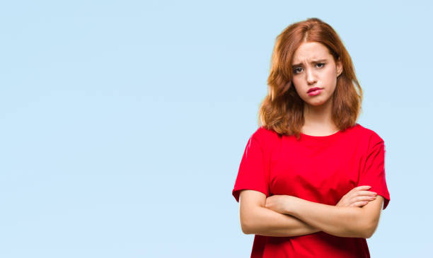 istock Young beautiful woman over isolated background skeptic and nervous, disapproving expression on face with crossed arms. Negative person. 1044292282