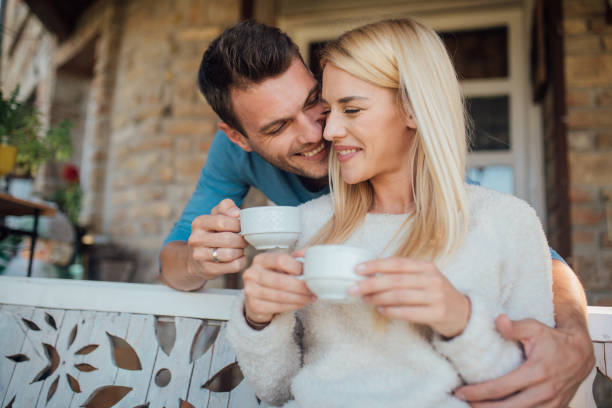 istock Man and woman hugging and drinking tea 1044292626