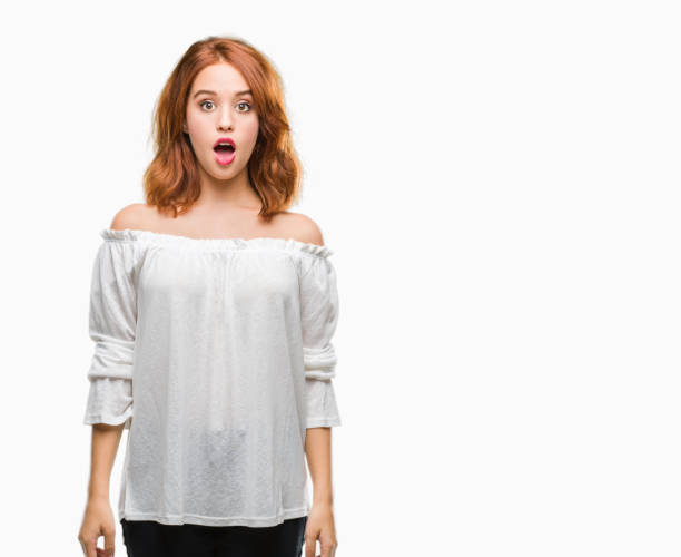 istock Young beautiful woman over isolated background afraid and shocked with surprise expression, fear and excited face. 1044292740