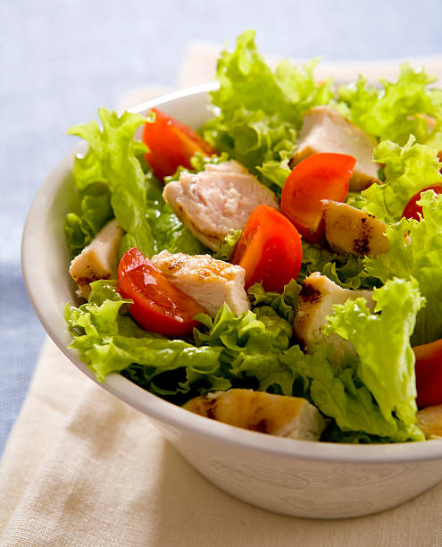 istock Bowl of Caesar salad showing chicken, tomato and lettuce 104429736
