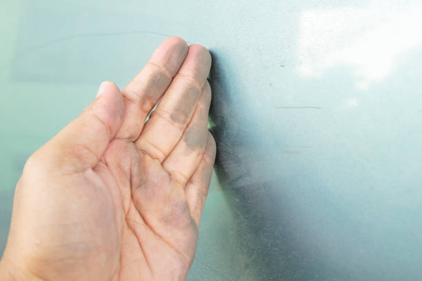 istock Hand with dirty car close up. 1044298176