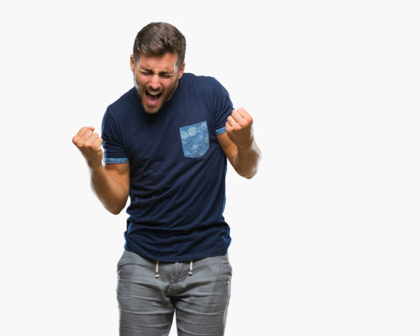 istock Young handsome man over isolated background very happy and excited doing winner gesture with arms raised, smiling and screaming for success. Celebration concept. 1044299456