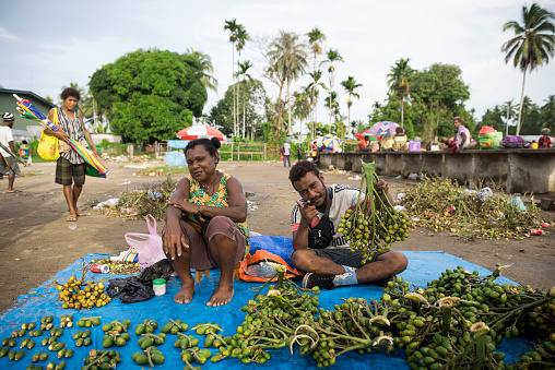 A man and woman sell betel nut and lime sticks at the market in Vanimo, Papua New Guinea (2017). Betel nut -- called 