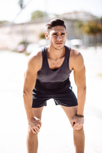 istock muscle man tired after jogging 1044303134