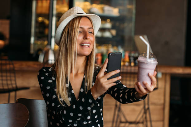 blogger woman takes milkshake photo - blueberry fruit berry berry fruit imagens e fotografias de stock