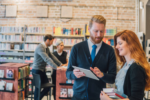 istock Man and woman looking at digital tablet 1044303298