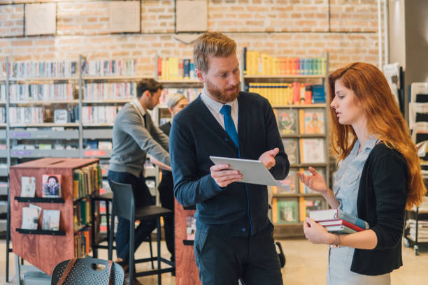 istock Man showing redhead woman his digital tablet 1044303314