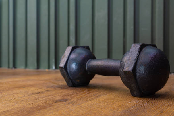 istock Black iron dumbbell on wooden floor 1044304030