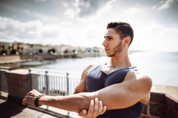 istock fitness man stretching the arm 1044306520