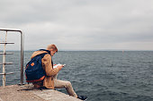 student-mit-rucksack-buch-auf-dem-seeweg