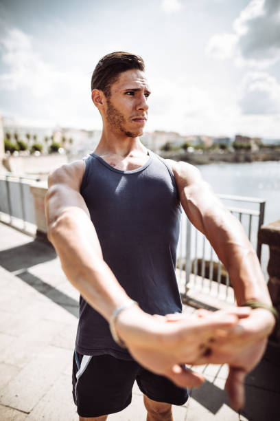 istock fitness man stretching the arm 1044307348