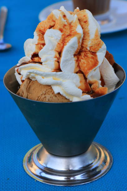 istock Cup of ice cream with whipped cream on a table 1044314542