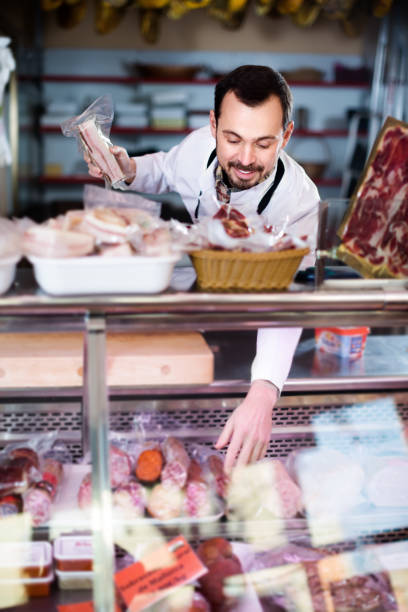 istock Positive man assistant working with meat 1044316102