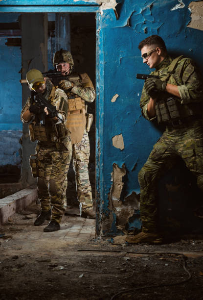 istock the people in uniform with weapons in the ruins 1044316186