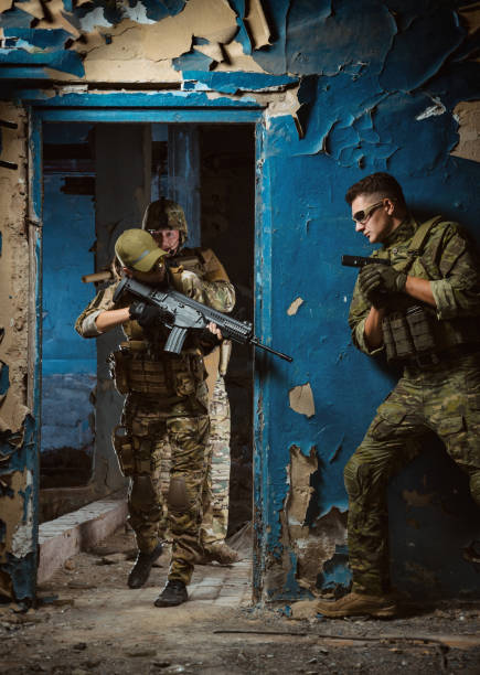 istock the people in uniform with weapons in the ruins 1044316194