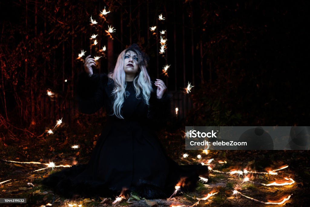 portrait with flashes of light around portrait of blonde girl in the dark with flashes of light around her Exorcism Stock Photo